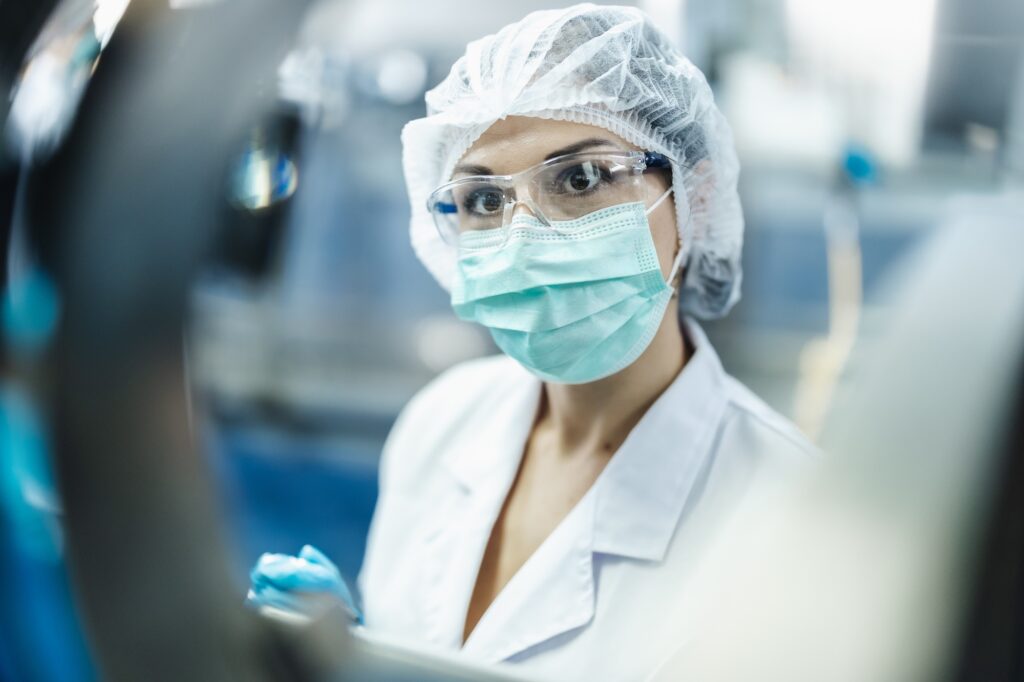 Hygiene worker in science laboratory. technician in pharmaceutical medicine production manufacturing